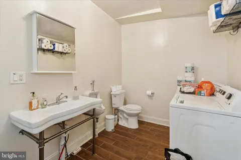 a bathroom with a sink toilet and a mirror