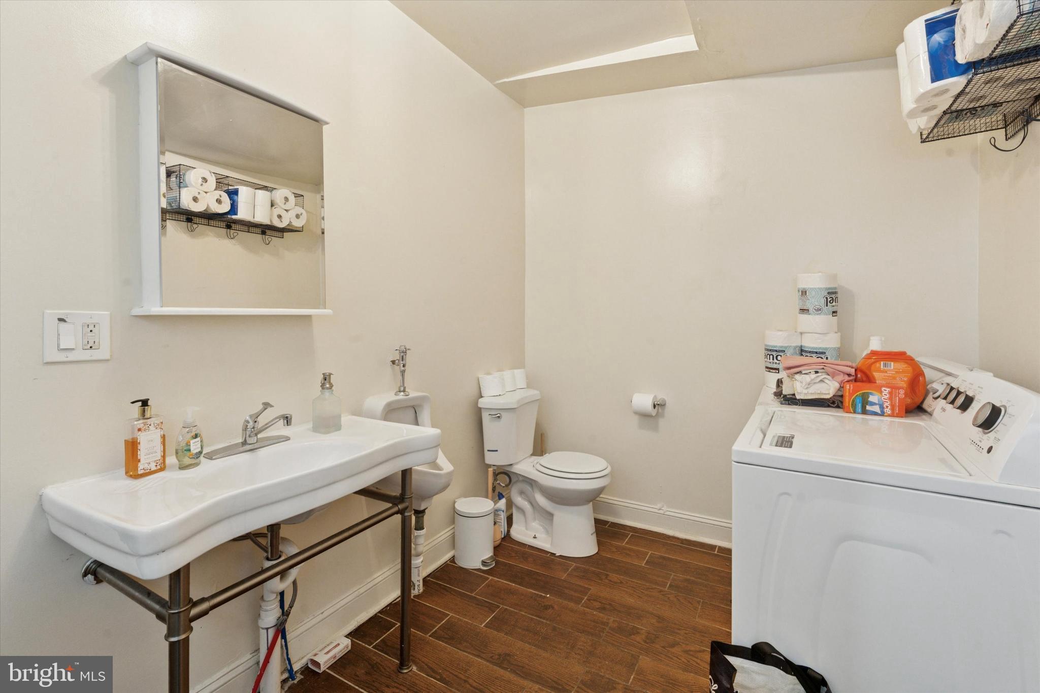 3817 Hamilton Street Philadelphia, PA 19104 - Photo 7 of 20 a bathroom with a sink toilet and a mirror