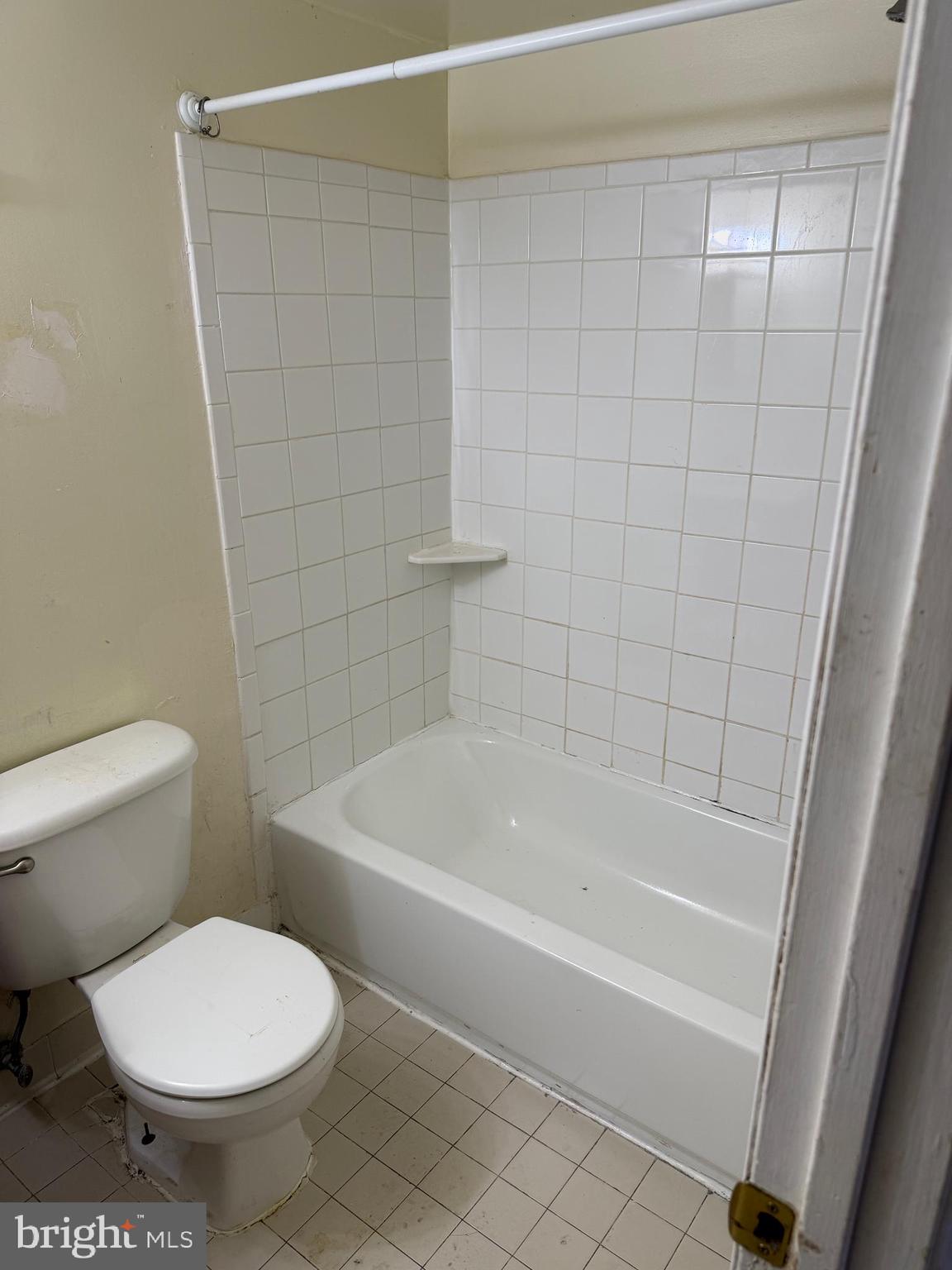 9342 Canterbury Riding, Unit 11 Laurel, MD 20723 - Photo 12 of 25 a white toilet sitting next to a bath tub