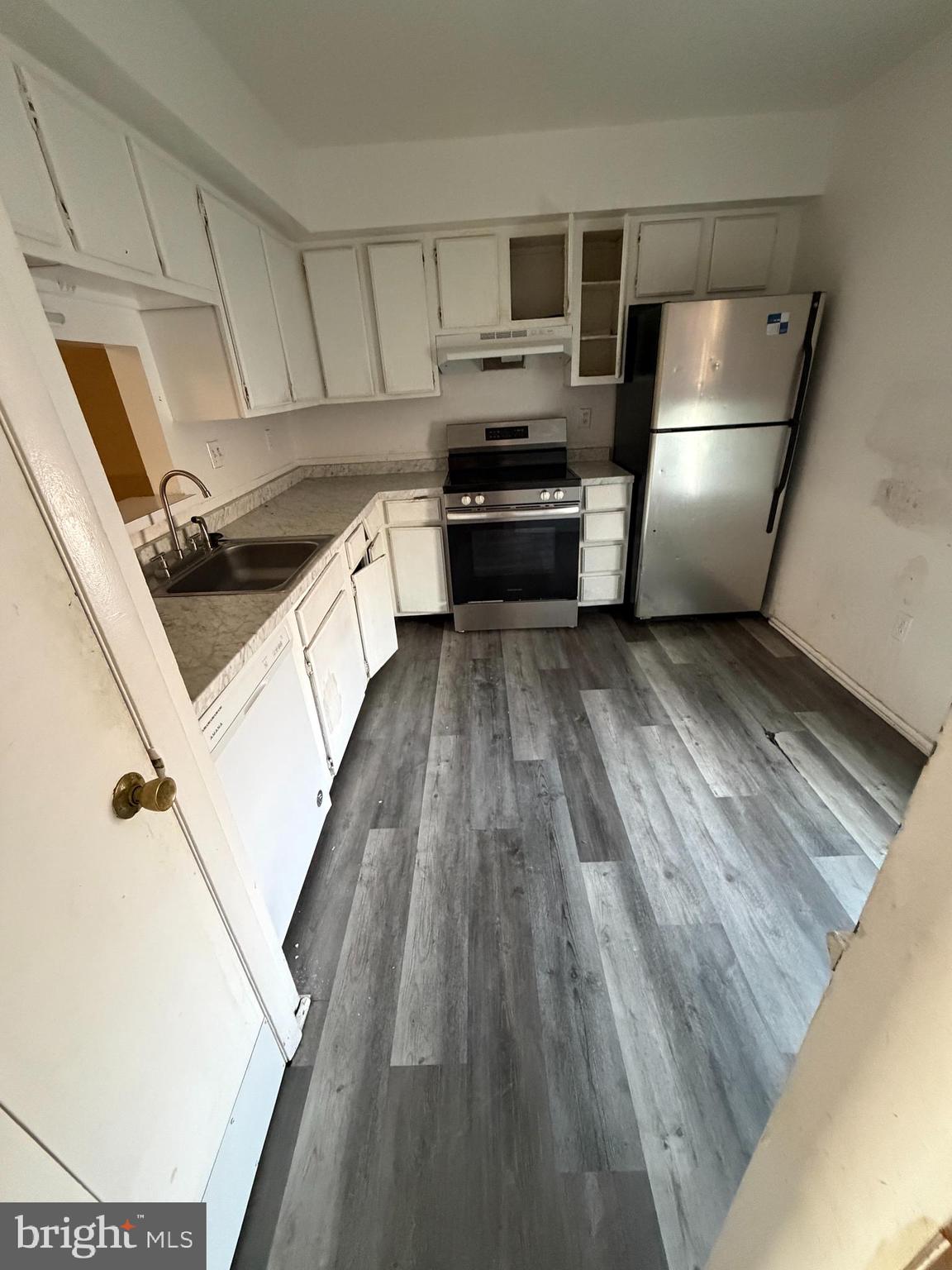 9342 Canterbury Riding, Unit 11 Laurel, MD 20723 - Photo 3 of 25 a kitchen with kitchen island wooden floors appliances and cabinets
