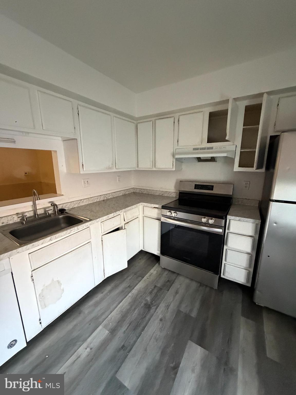 9342 Canterbury Riding, Unit 11 Laurel, MD 20723 - Photo 4 of 25 a kitchen with granite countertop stainless steel appliances and wooden cabinets