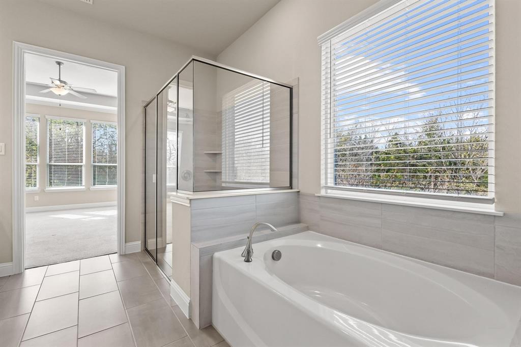 4001 Gentle Creek Lane Nevada, TX 75173 - Photo 23 of 40 a bathroom with a bathtub and a shower