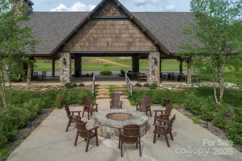 316 River Club Drive, Unit 3 Cullowhee, NC 28723 - Photo 12 of 23 a view of a patio with table and chairs and potted plants