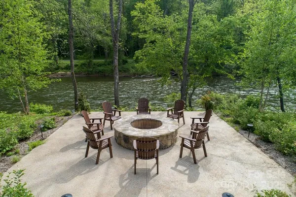 a table and chairs with the wooden fence