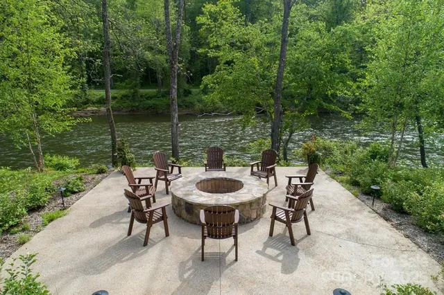 a table and chairs with the wooden fence