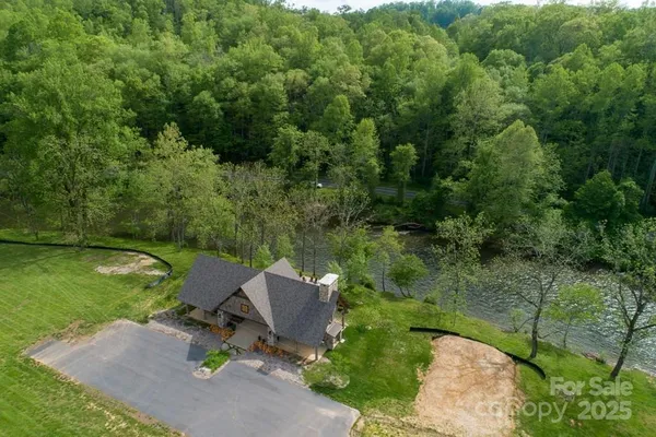 an aerial view of a house with pool garden and outdoor seating
