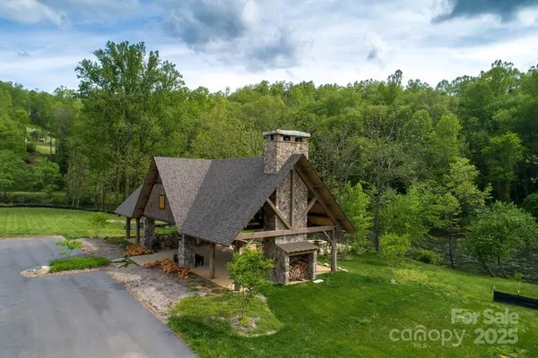 an aerial view of a house with swimming pool and green space