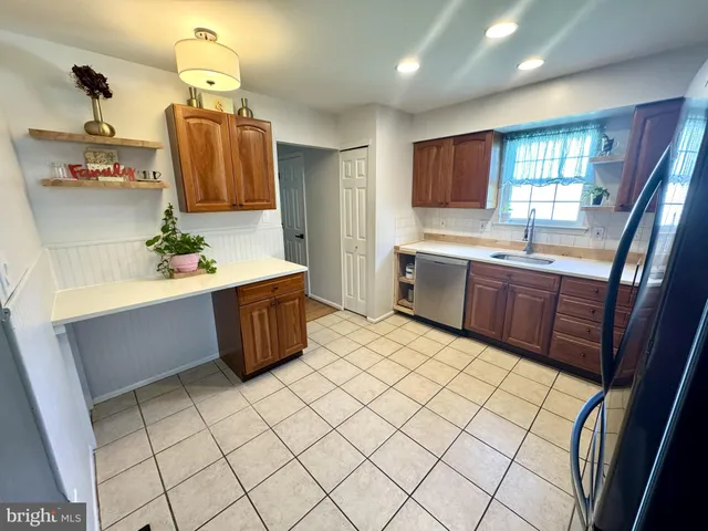 a kitchen with stainless steel appliances a sink and a refrigerator