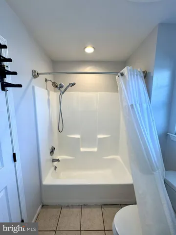 a bathroom with a tub and shower
