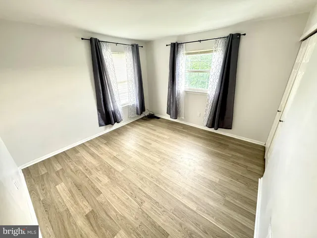 a view of an empty room and wooden floor