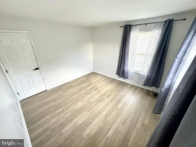 a view of an empty room and wooden floor