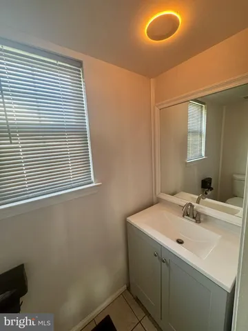 a bathroom with a sink and a window