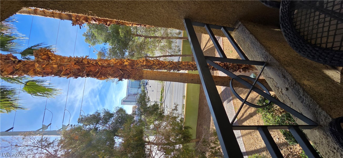 210 East Flamingo Road, Unit 208 Las Vegas, NV 89169 - Photo 26 of 42 Enjoy views of the city strip and lush palm trees from this inviting outdoor balcony.