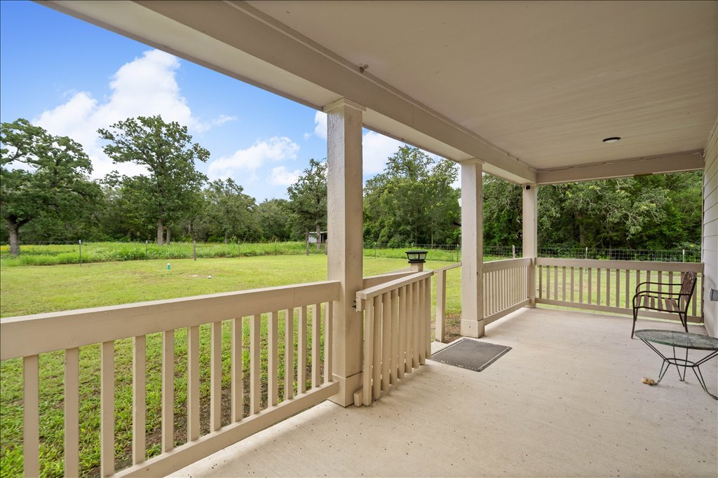 608 Whistleville Road Flatonia, TX 78941 - Photo 13 of 26 Let’s step outside onto the covered back porch. You can easily set up a few rocking chairs or an outdoor dining table. Look at that view, private and peaceful.