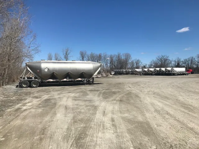 a front view of a house with a yard and wooden fence