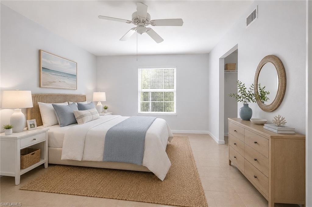 5737 Whitaker Road, Unit C101 Naples, FL 34112 - Photo 6 of 28 a spacious bedroom with a bed a mirror on dresser and a window