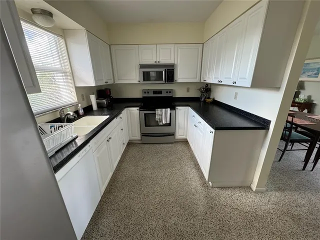 a utility room with dryer washer and other items