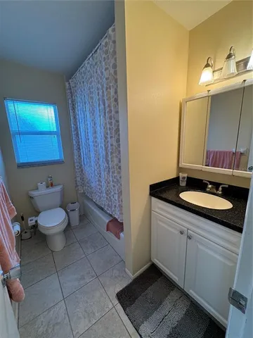 a bedroom with bed and a window