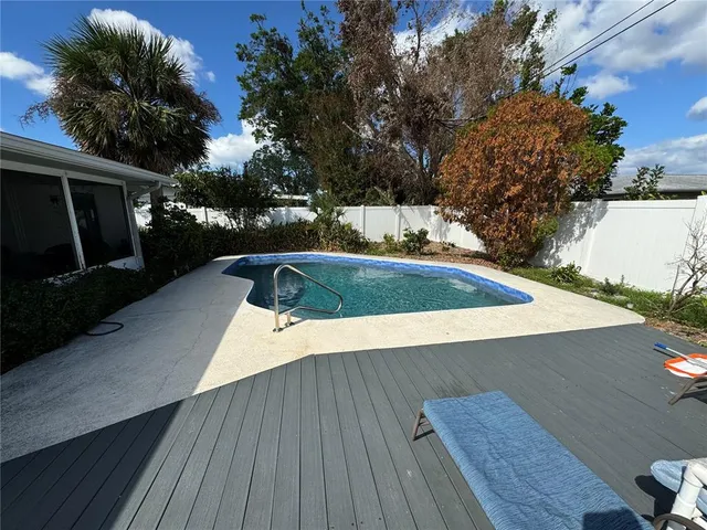 a view of a balcony with wooden floor and potted plants