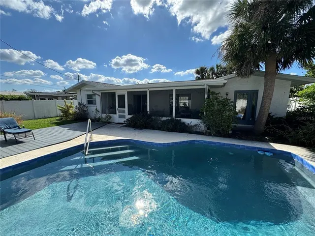 a view of a house with backyard and garden