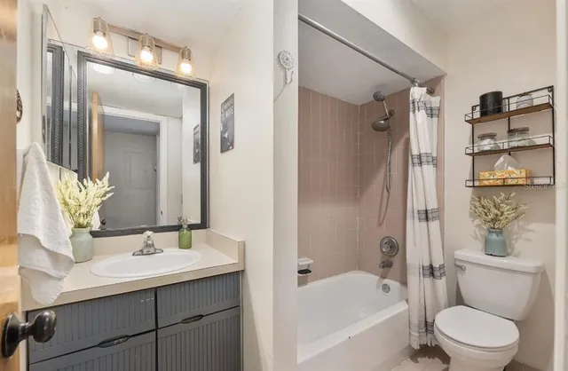 a white toilet sitting next to a bathroom sink
