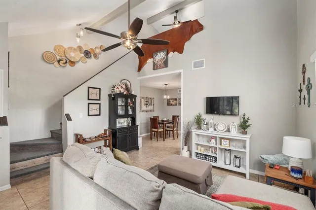 a view of a dining room with furniture and chandelier