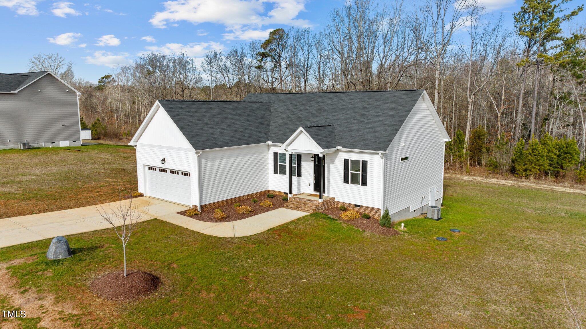 30 Brookhaven Drive Spring Hope, NC 27882 - Photo 18 of 20 a aerial view of a house next to a yard with large trees