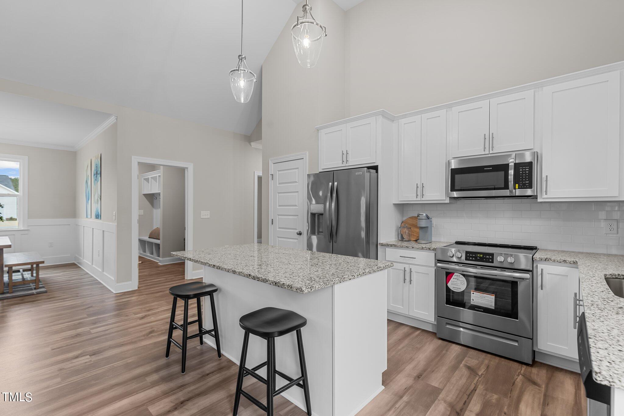 30 Brookhaven Drive Spring Hope, NC 27882 - Photo 3 of 20 a kitchen with stainless steel appliances a stove a sink island and a refrigerator