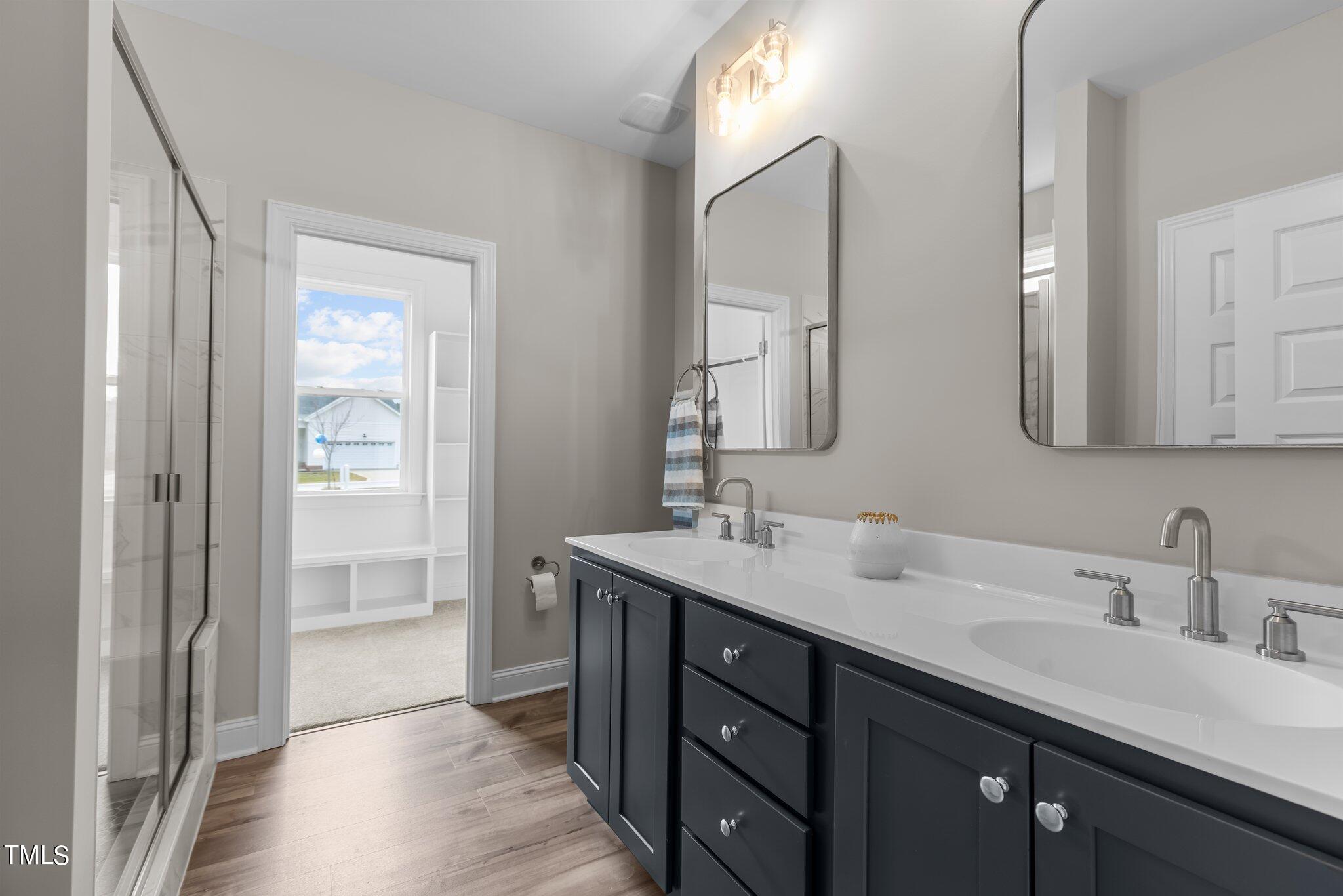 30 Brookhaven Drive Spring Hope, NC 27882 - Photo 10 of 20 a bathroom with a double vanity sink and mirror with shower