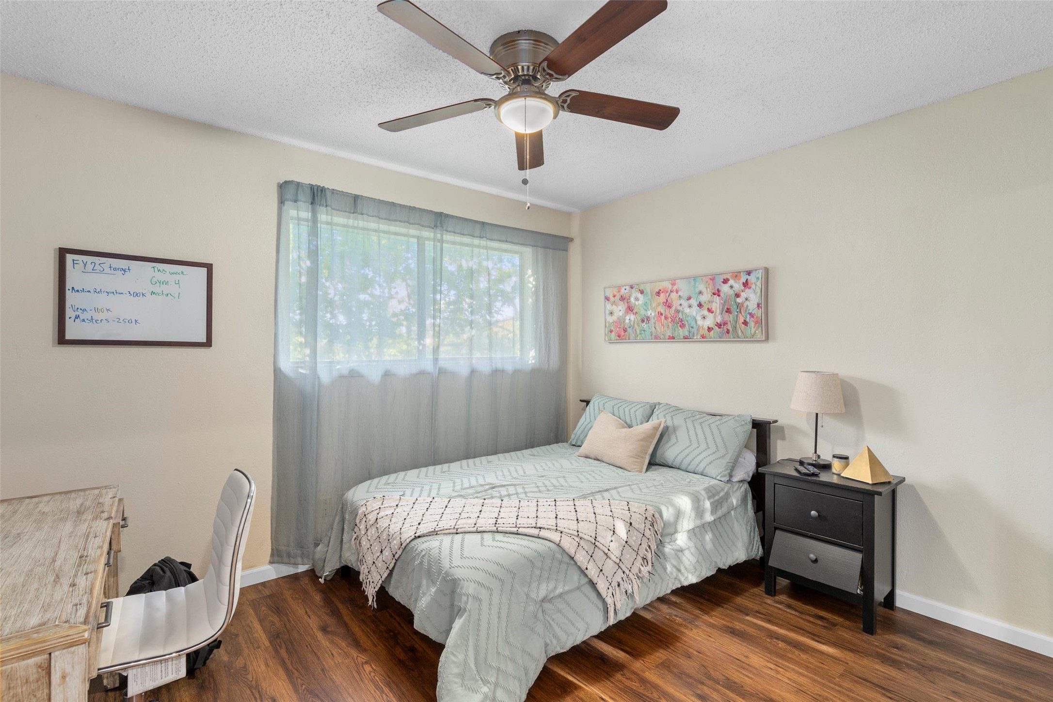 6492 Hart Lane Austin, TX 78731 - Photo 11 of 22 Bedroom with dark wood finished floors, a textured ceiling, a ceiling fan, and a desk