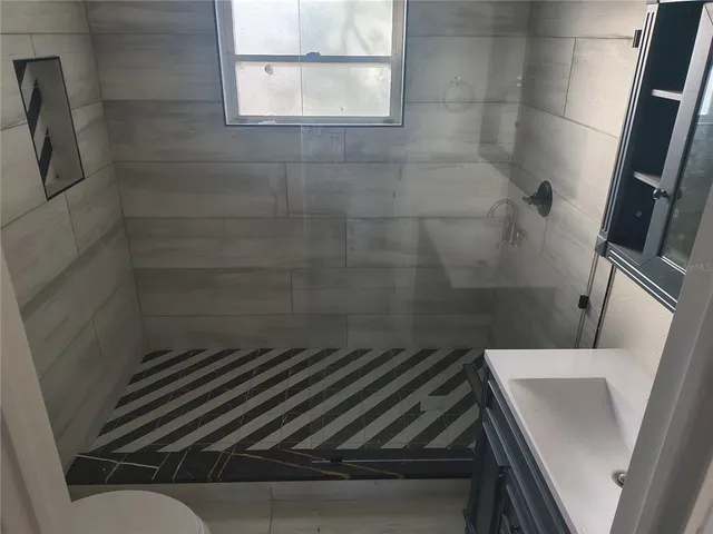 a view of a kitchen with dishwasher and a window