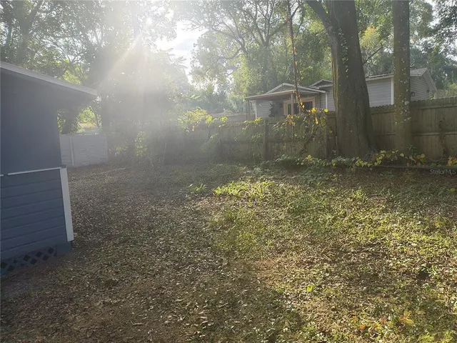 a backyard of a house with lots of green space