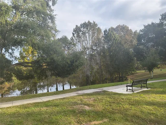 a swimming pool with trees in the background