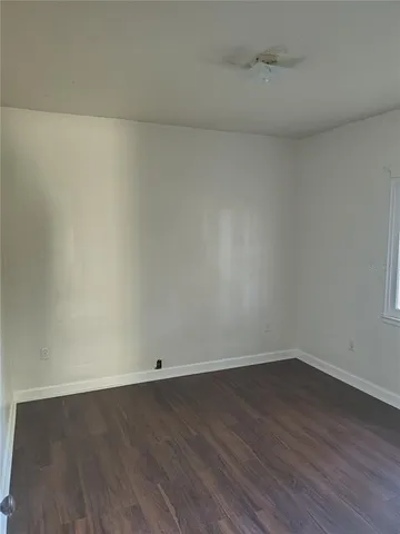 wooden floor and cabinet in an empty room