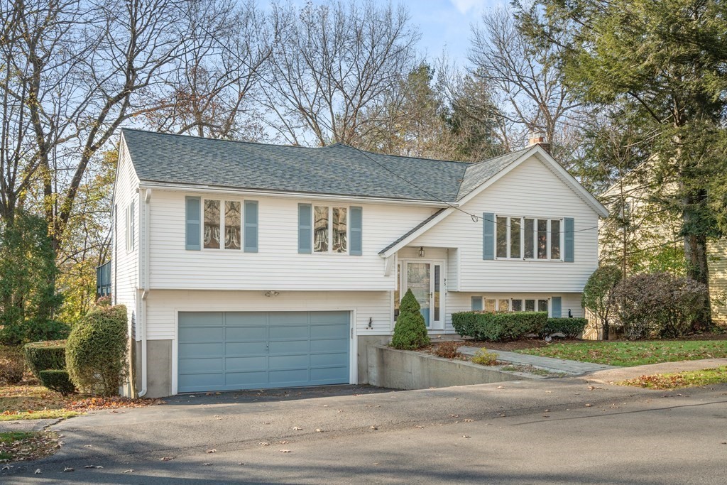93 Gayland Road Needham, MA 02492 - Photo 1 of 36 a front view of a house with a yard and garage