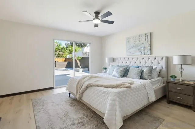 a bedroom with a bed and a large window