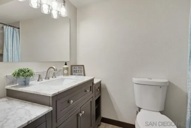 a bathroom with a sink toilet and a mirror