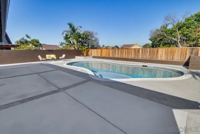 a view of swimming pool with an outdoor seating
