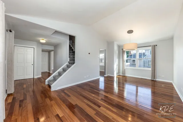 a view of an entryway with wooden floor