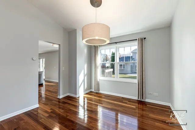 a room with wooden floor and window