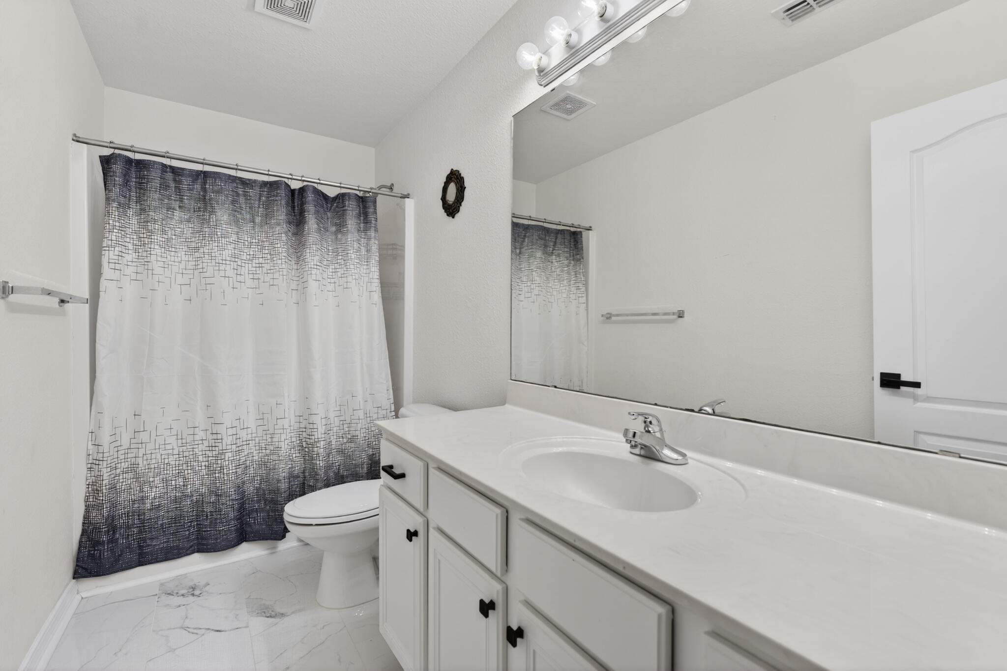 268 Loblolly Bay Drive Santa Rosa Beach, FL 32459 - Photo 34 of 73 a bathroom with a sink a toilet a mirror and shower