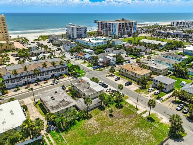 an aerial view of residential houses with yard