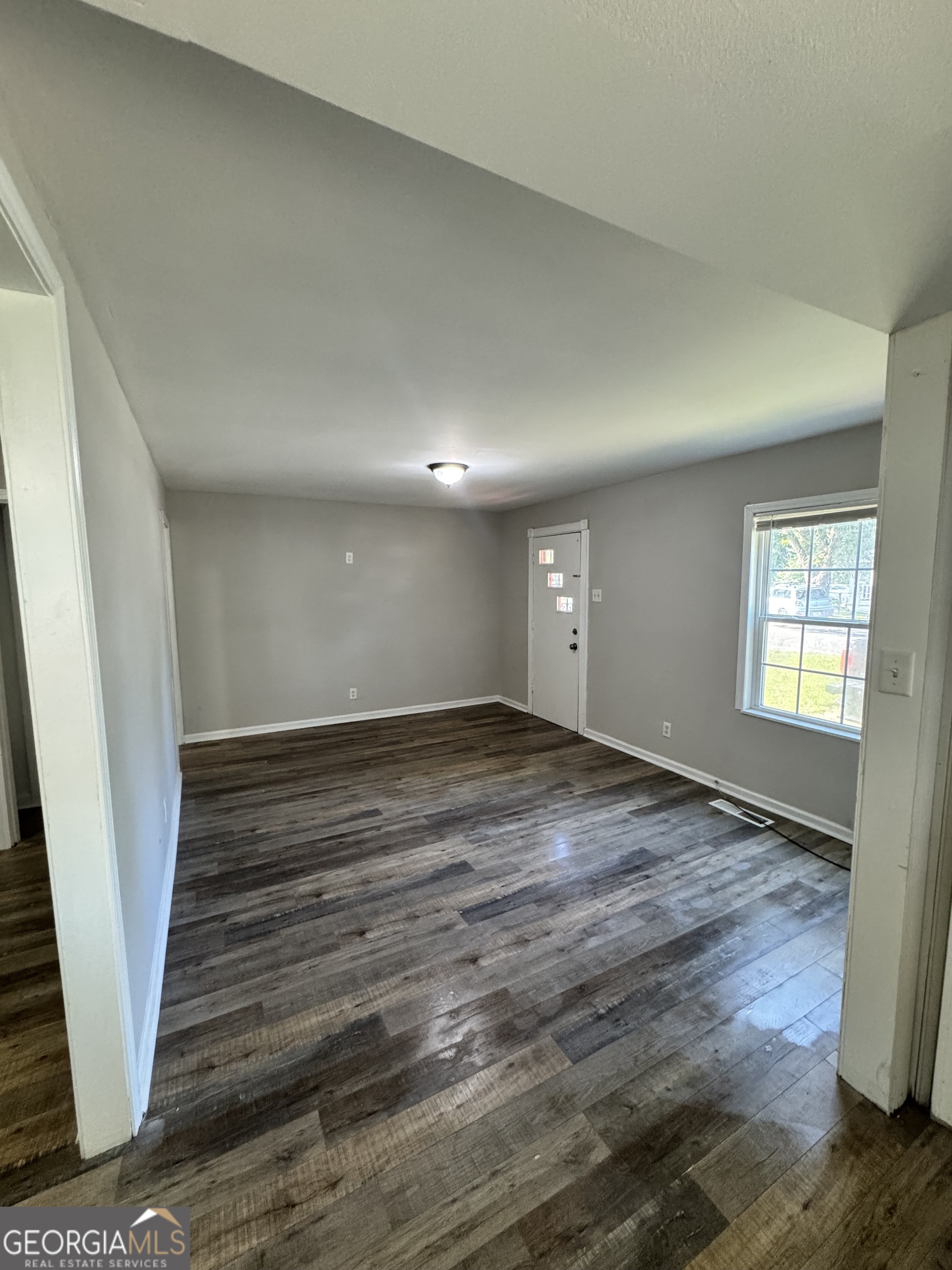 1282 Hartley Street Macon, GA 31206 - Photo 5 of 15 wooden floor in an empty room with a window