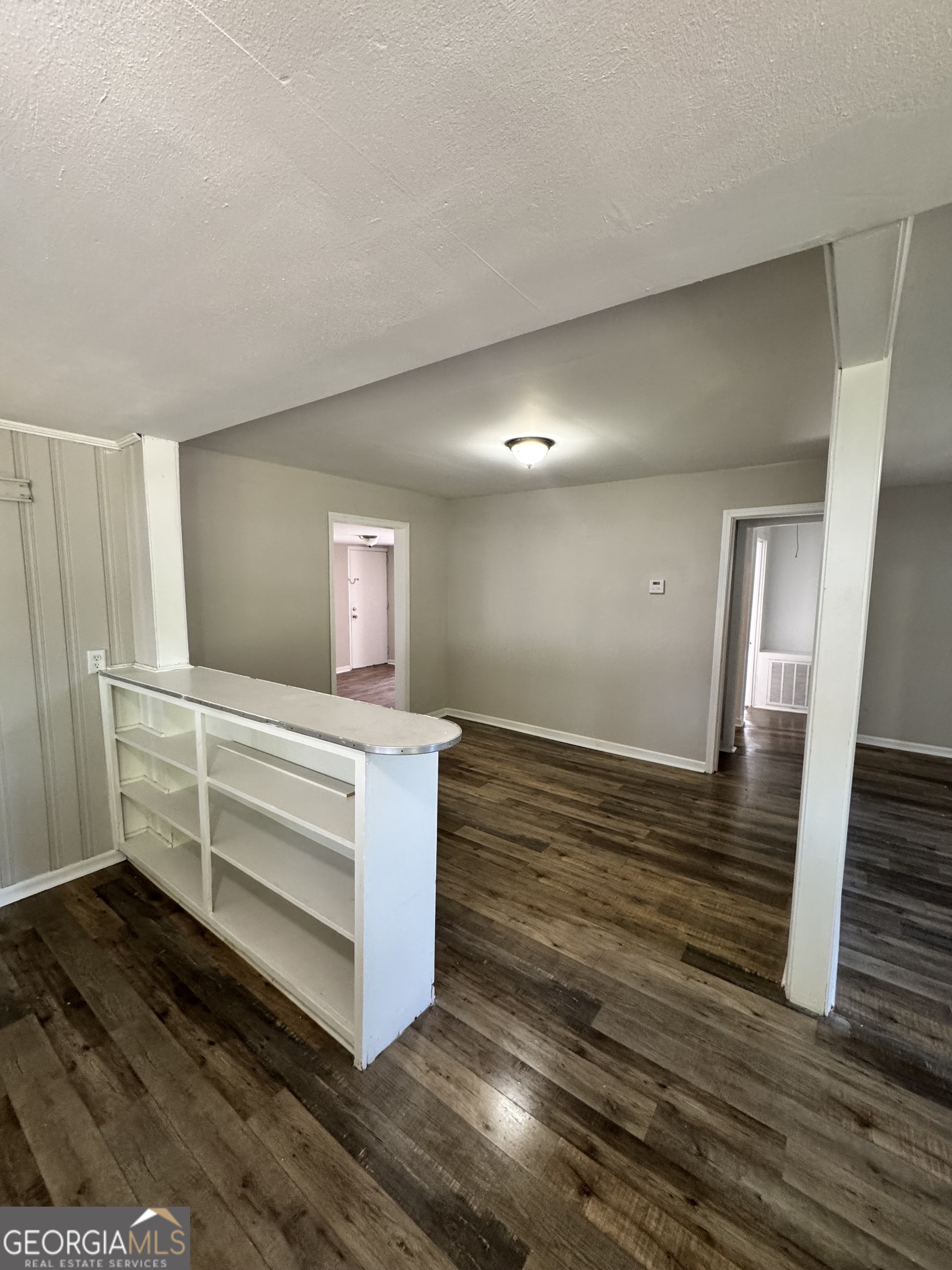1282 Hartley Street Macon, GA 31206 - Photo 6 of 15 a view hallway and an empty room with wooden floor
