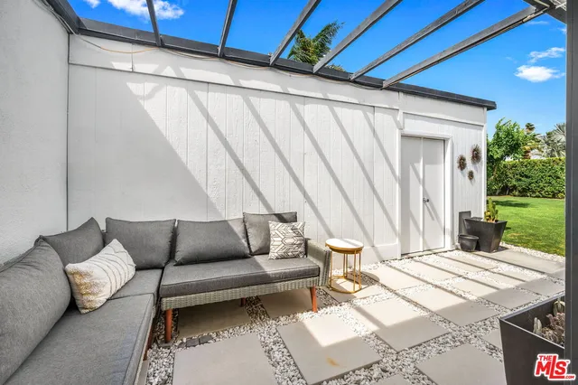 a living room with furniture and a white umbrella