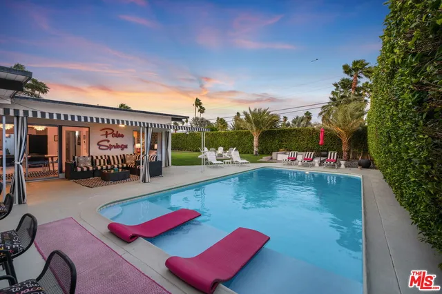 a view of swimming pool with seating space