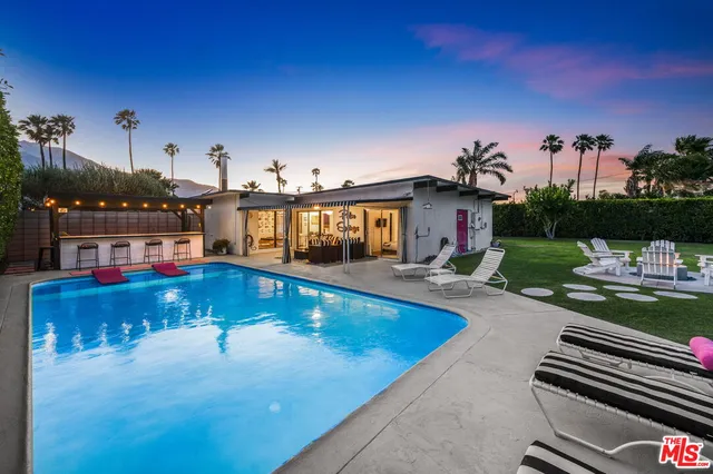 a view of swimming pool with outdoor seating