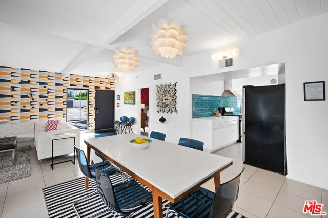 a view of a dining room with furniture and a kitchen
