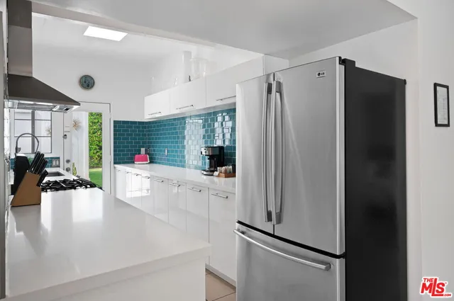 a kitchen with stainless steel appliances a refrigerator and a stove