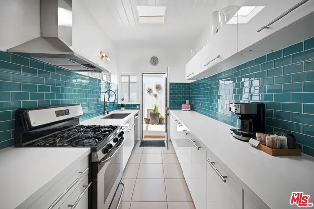 a kitchen with a sink and a stove top oven